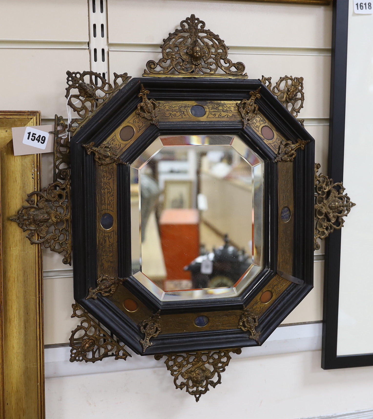 A 19th century Italian gilt bronze and hardstone-mounted ebony octagonal mirror, 52 x 48cm